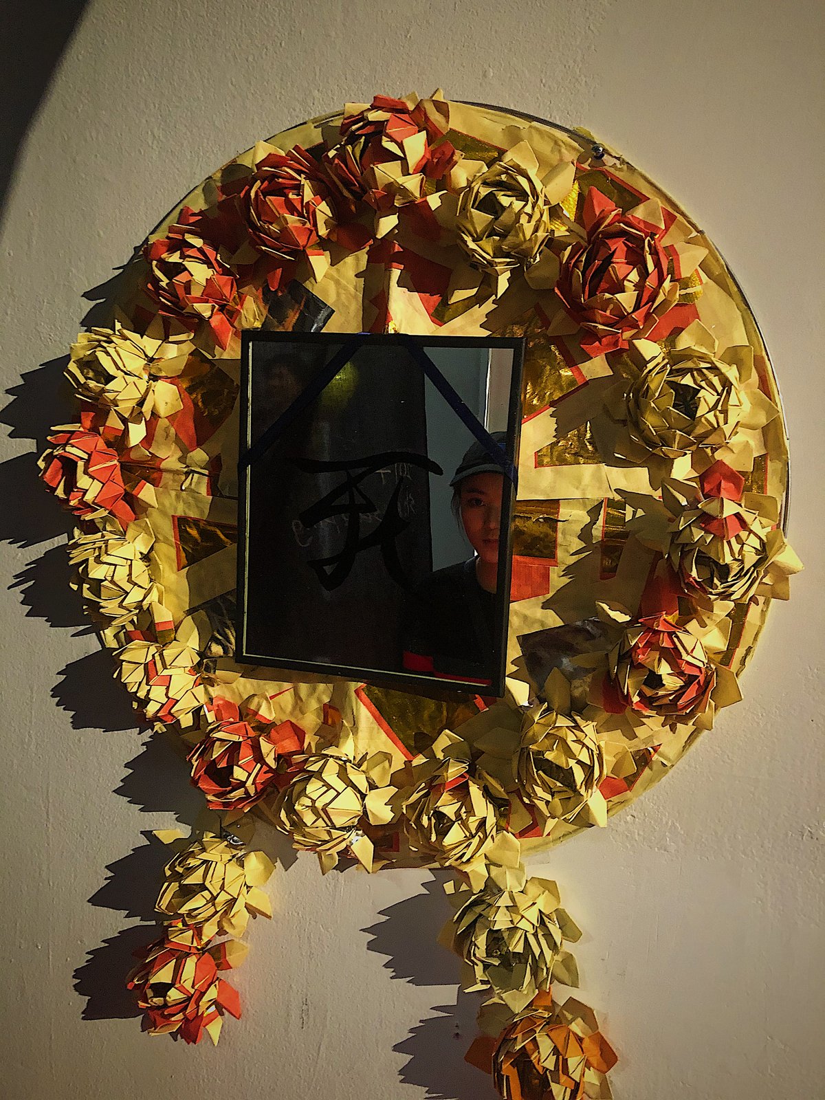 Grief & Bereavement — circular mirror surrounded by joss-paper lotuses