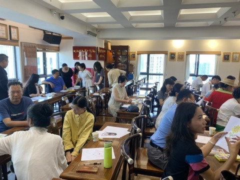 Workshop participants in conversation across small tables