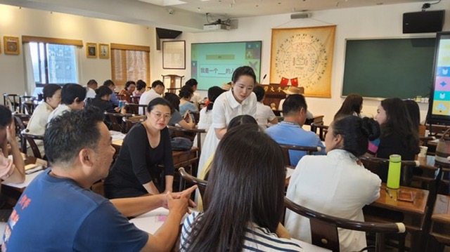 Workshop in a Chinese classroom, participants working in pairs
