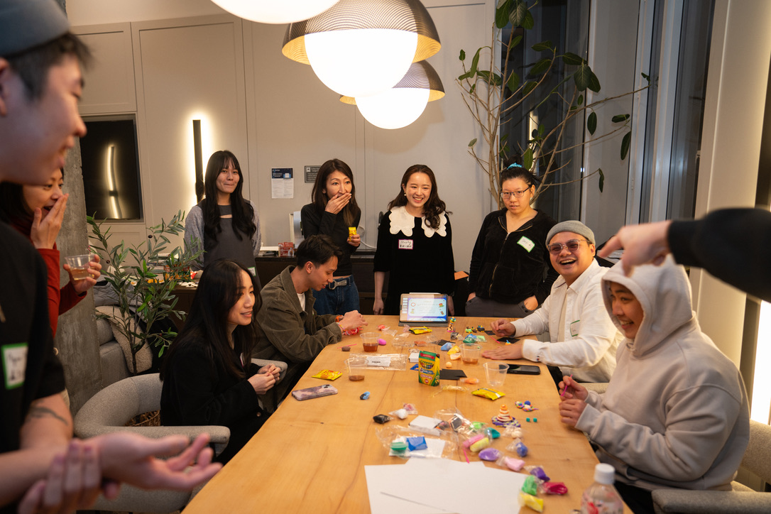Evening community workshop around a long wooden table