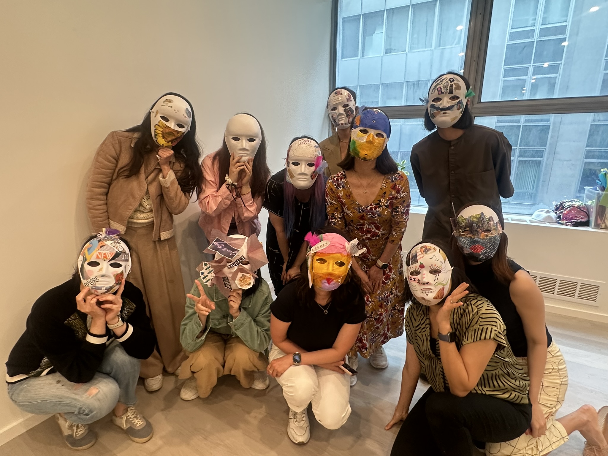 Group portrait of participants holding their finished masks
